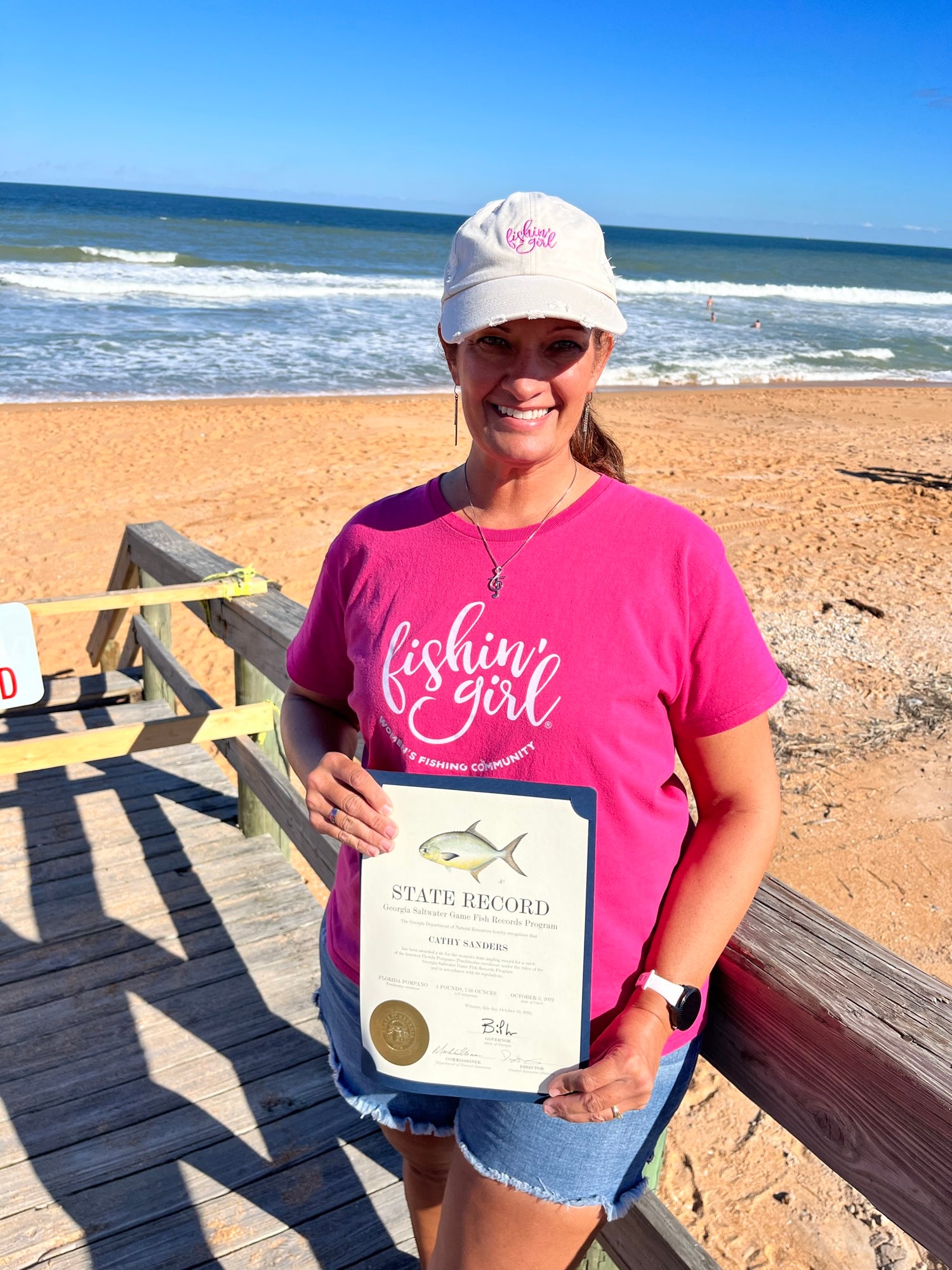 Cathy Sanders holding the GA state record certificate she won in 2022.